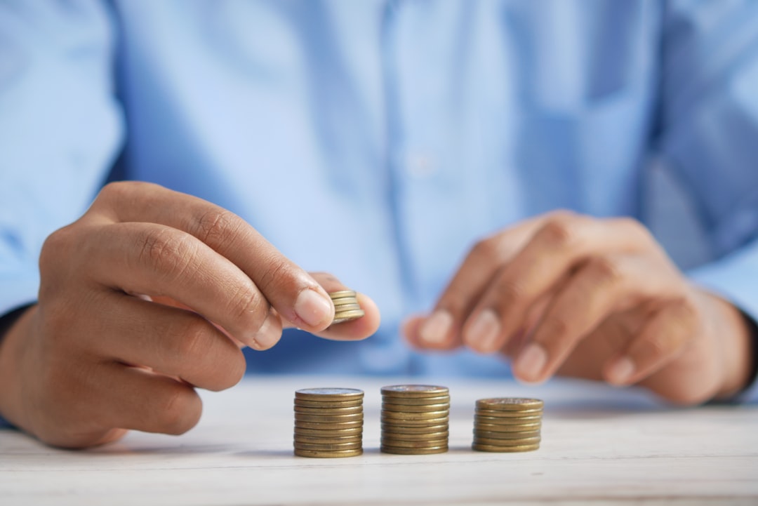 home-services-004 a-person-stacking-coins-on-top-of-a-table-jpqyfk7gb4w