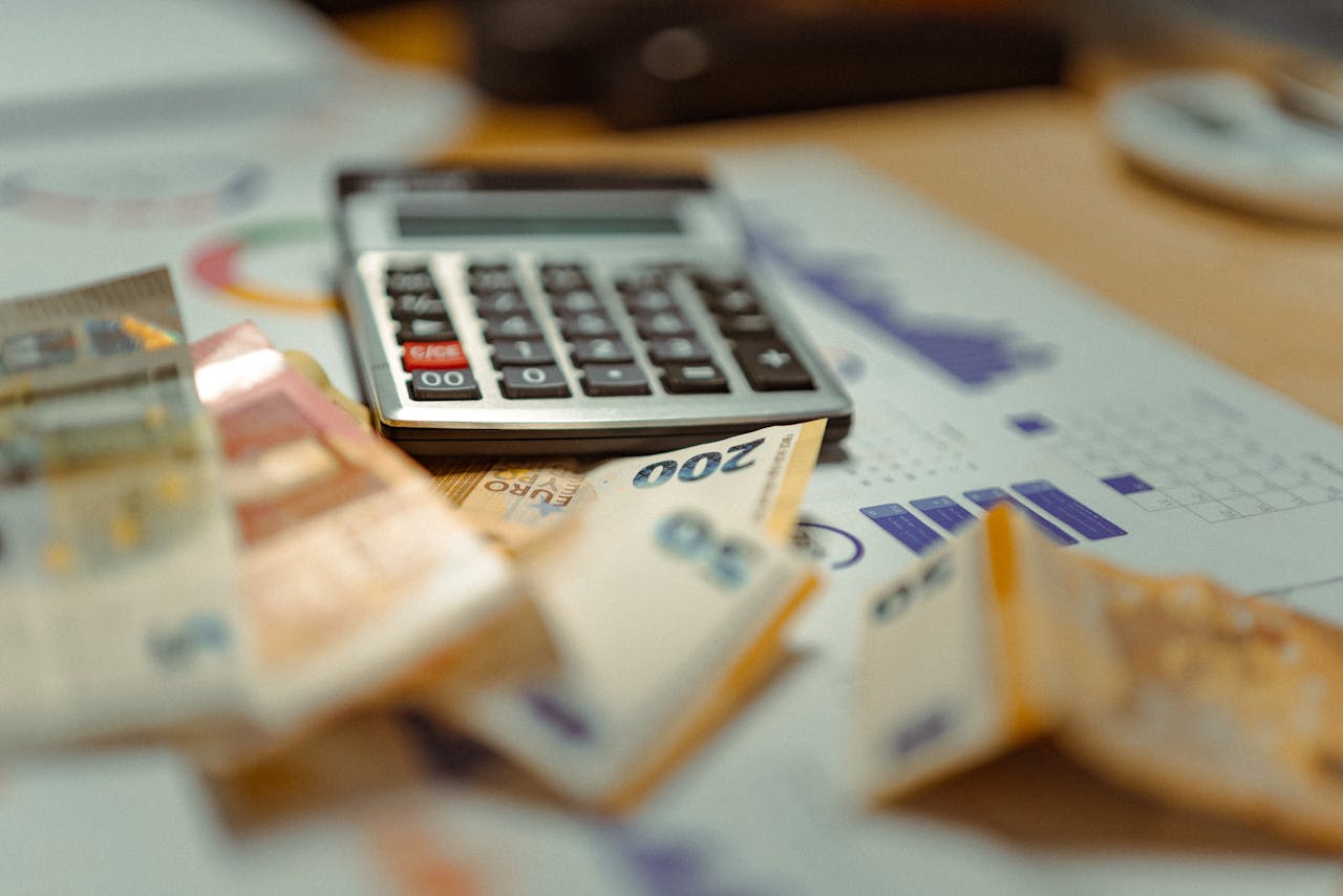 home-hero-bg Euro banknotes and calculator on financial documents, focusing on business budget planning.